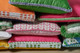 Close-up of stacked cushions showcasing Christopher Farr Cloth fabrics and trims, highlighting custom opportunities for ClothShop accessories using the full range of Christopher Farr Cloth materials.